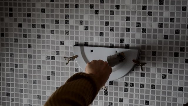 Electrician replacing old wall lamp