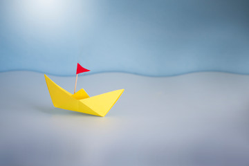 One origami boat on blue sea still life.