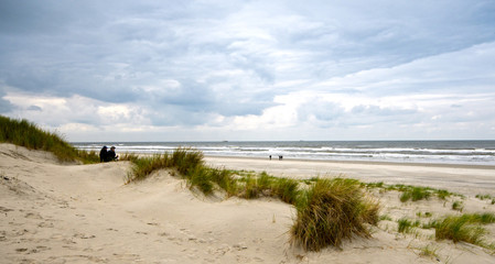 Fototapeta na wymiar Dune beach on the North Sea island Langeoog in Germany with clouds on a beautiful summer day, holidays in Europe