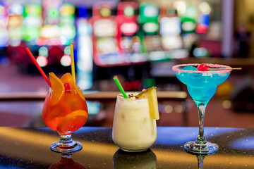 Assortment of different cocktails on the bar. Few fashion cocktails different colours.