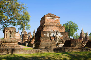 Fototapeta na wymiar On the ruins of an ancient Buddhist temple Wat Mahathat. Historical Park of Sukhothai, Thailand