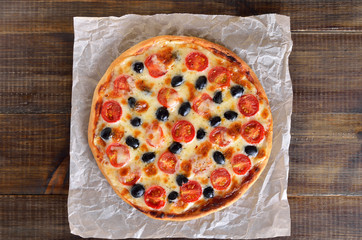 Appetizing homemade pizza with tomato and olives