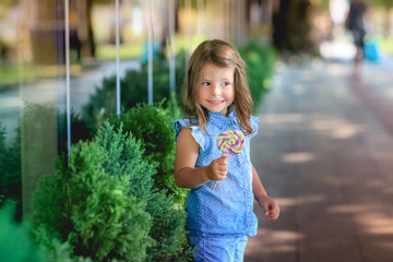 Child for a walk in the park with candy in hand