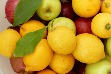lemon on a leaf, a large amount of natural lemon in a container, yellow lemons,