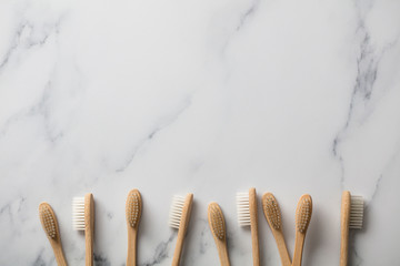 Wooden bamboo toothbrushs on a marble background