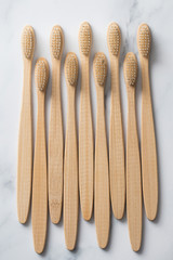Wooden bamboo toothbrushs on a marble background