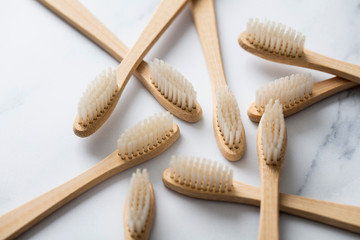 Wooden bamboo toothbrushs on a marble background