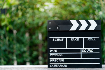 movie clapper on wood table outdoor ; film, cinema and vedio photography concept