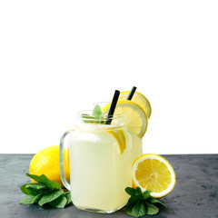 Refreshing lemonade drink with lemon slice and mint in the jar on dark table and white background
