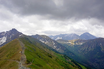 Fototapeta premium Tatra Mountains, Poland. View from Kasprowy Wierch to Swinica mount, tourists on the trail