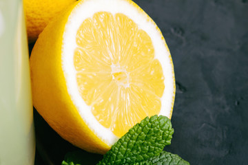 Lemon halves and mint on a dark background