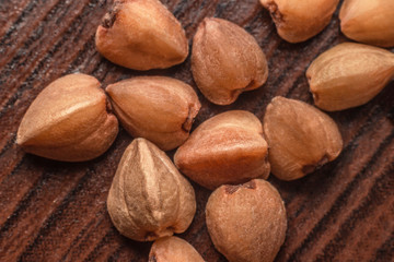 buckwheat grains on a wooden surface macro