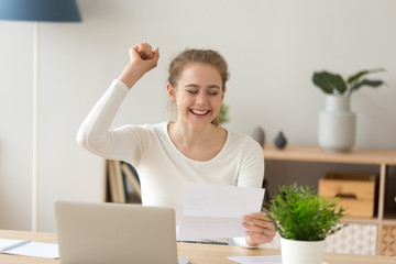 Happy excited teen girl student reading college admission letter