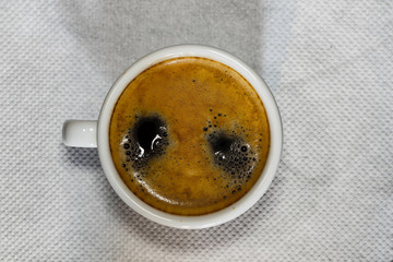 Cup of Espresso coffee on white napkin, espresso creme. © Vlad Ispas