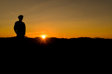 Fototapeta premium Silhouette of man at sunset, Concept lifestyle freedom vacation travel.