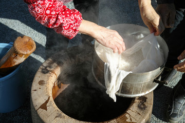 An elderly couple looking at the mochigome (rice used to make mochi) before putting it the large mortar