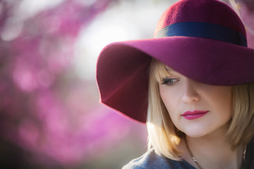 portrait of a blonde with blue eyes in a red hat