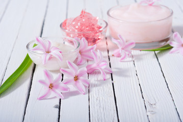 Obraz na płótnie Canvas beauty products with hyacinth flowers on white wood