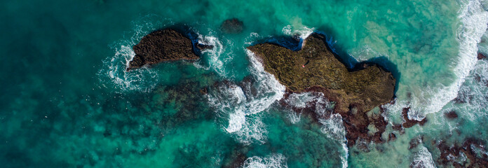 Wide angle landscape image of the dramatic sandstone rock formations along the coastline of Arniston in th Western Cape of South Africa.