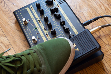 guitarist foot on guitar effect pedal in a studio