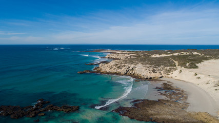 Wide angle landscape image of the dramatic sandstone rock formations along the coastline of Arniston in th Western Cape of South Africa.