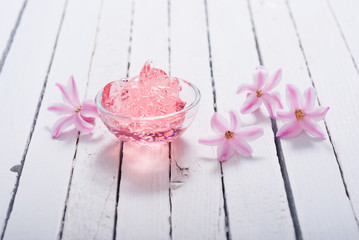 anti aging gel and hyacinth flowers on white wood