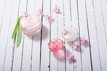 beauty products with hyacinth flowers on white wood