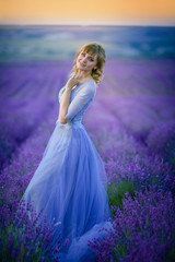 Fototapeta premium Beautiful Bride in wedding day in lavender field. Newlywed woman in lavender flowers.