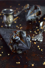 Black ice cream with sesame and caramel in black waffle ice cream cones. Copy space. Trendy summer food