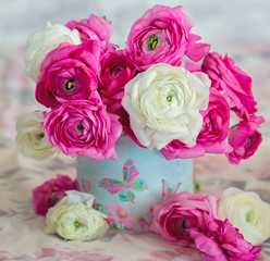 Floral composition with a pink and white Ranunculus flowers.