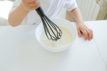 Five years boy enjoy cooking making pancakes in the morning, happy childhood