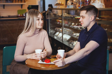 Two cute young boy and girl in a cafe.