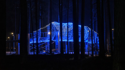 Jurmala Winter snowy mežaparks park with Christmas decorations (garlands, figures, neon lights)