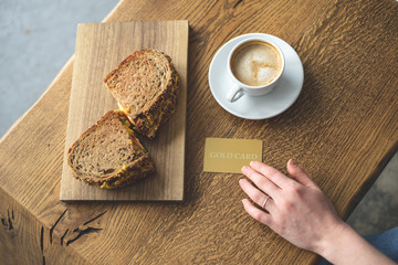 Group of breakfast object on wooden table - coffee, snack and plastic card