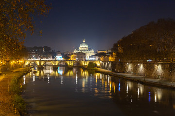 Rome night skyline with Vatican St Peter Basilica and St Angelo Bridge crossing Tiber River in the...