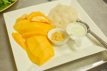 Delicious Mango with sticky rice, with coconut sauce in local restaurant in Bangkok, Thailand.