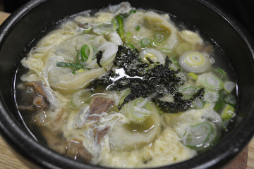 White smooth soup with seaweed on top in Korea