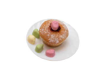 Cupcake and candy on a saucer on white background, isolate