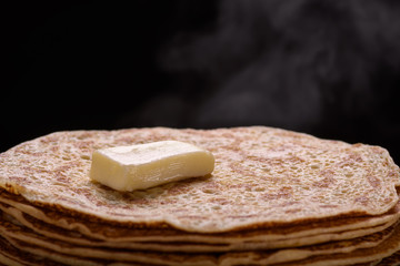 Hot pancakes with a piece of butter