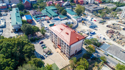 Fototapeta na wymiar New multi-storey residential building on the shore of the beautiful Gelendzhik Bay. Black sea coast of the Caucasus, resorts of Kuban. Another residential complex is being built nearby. In the backgro