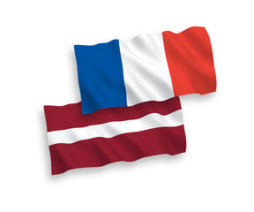 National vector fabric wave flags of France and Latvia isolated on white background. 1 to 2 proportion.