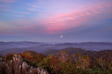 Hazy evening moonrise at sunset over unicoi mountains in North Carolina