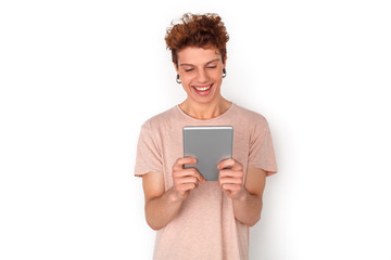 Teenager with earrings studio standing isolated on white video chat on digital tablet cheerful