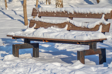 wooden park bench snow winter