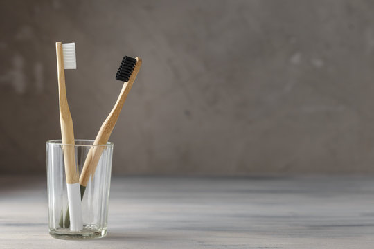 Two eco friendly bamboo tooth brushes in a glass