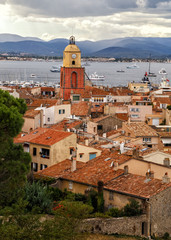 Fototapeta premium View to the rooftops and church tower of the old town of Saint Tropez, French Rivera, France. Vertical cityscape. Holidays in France.