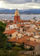 View to the rooftops and church tower of the old town of Saint Tropez, French Rivera, France. Vertical cityscape. Holidays in France.