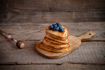Pancakes with berries and maple syrup and sugar powder