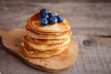 Pancakes with berries and maple syrup and sugar powder