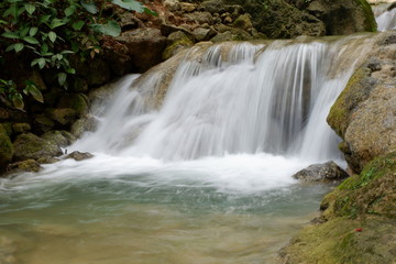 Fototapeta na wymiar beautiful waterfalls flowing from springs in the forest